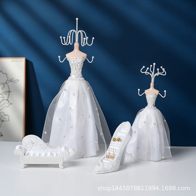 Elegant white stand holding various jewellery pieces