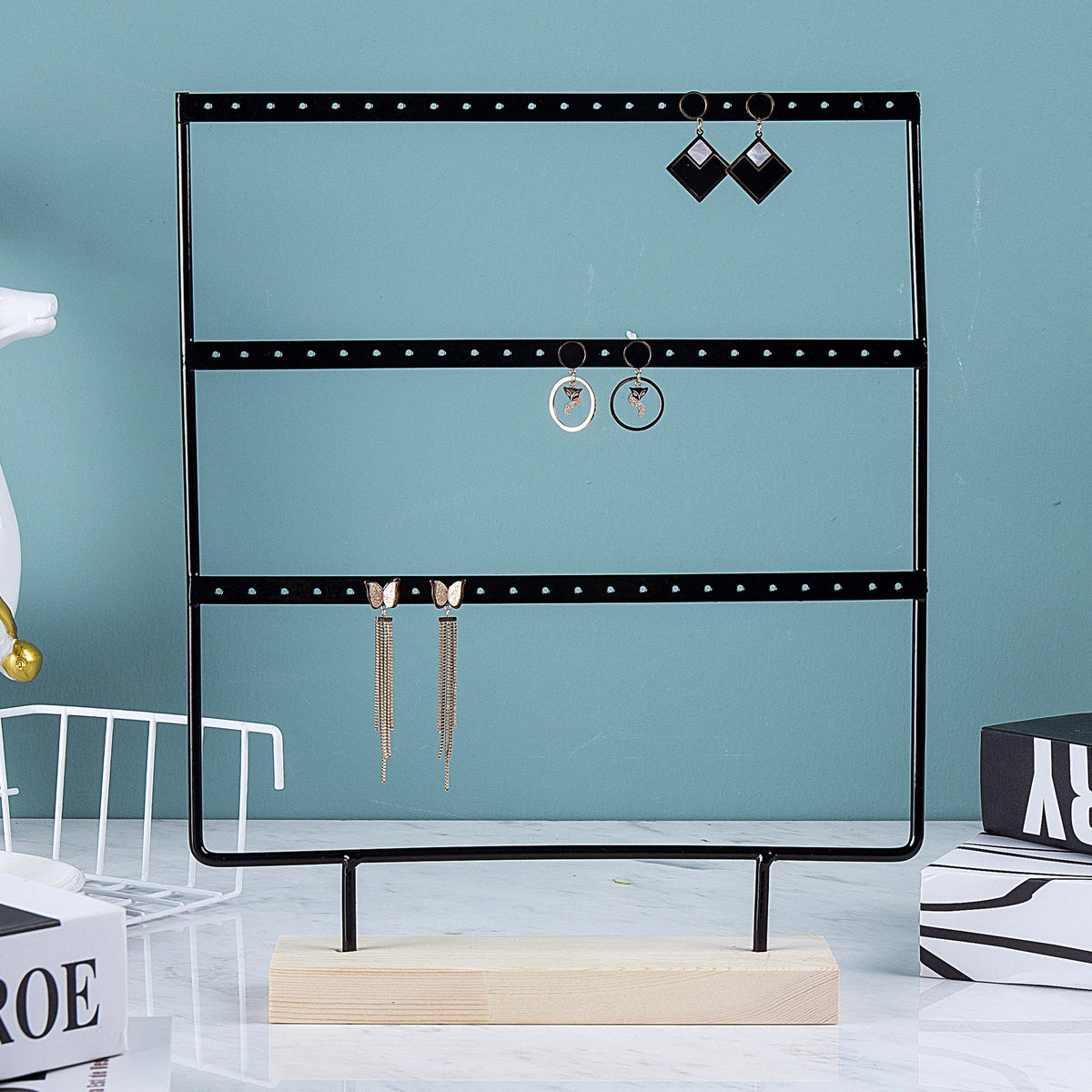 Close-up of Metal Earring Holder with Wooden Base - Image 2