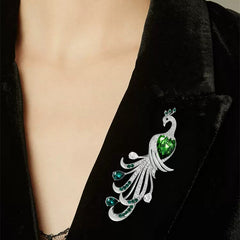 Elegant green zircon peacock brooch on display