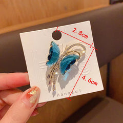 Close-up of tassels on butterfly brooch