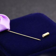 detailed view of red rose brooch