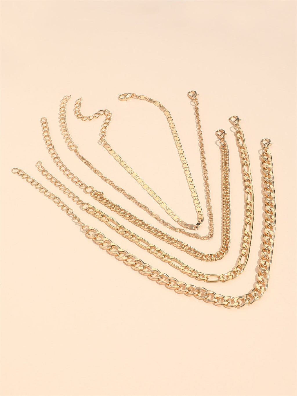 Woman styling multiple anklets for a layered look