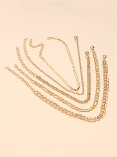 Woman styling multiple anklets for a layered look