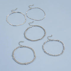 Stacked view of multiple snake chain anklets