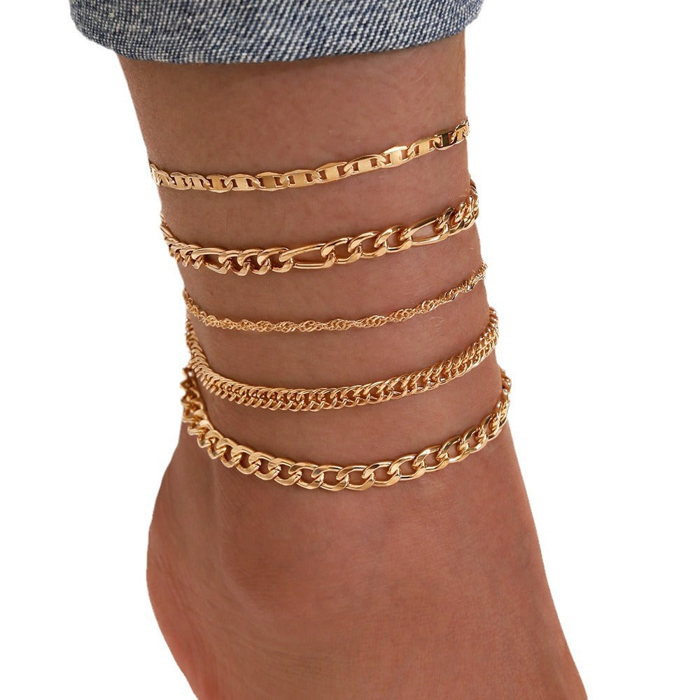 Stylish vintage anklet set displayed on a stand
