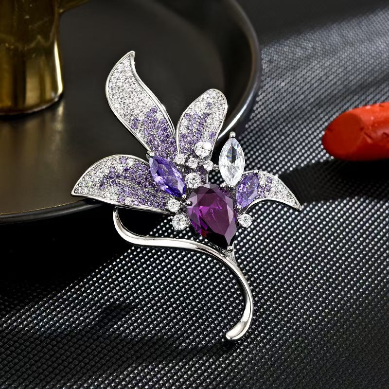 Purple lily brooch on a stylish jacket