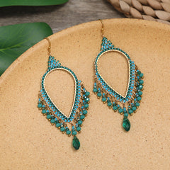 Artistic handmade earrings on velvet
