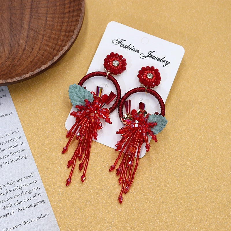 Colorful floral earrings displayed on neutral background