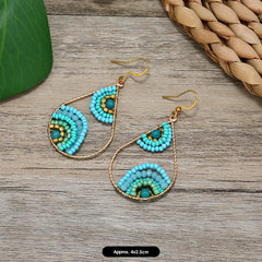 Bohemian earrings showcased against vibrant background
