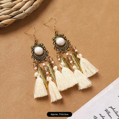close-up of white bohemian feather earrings