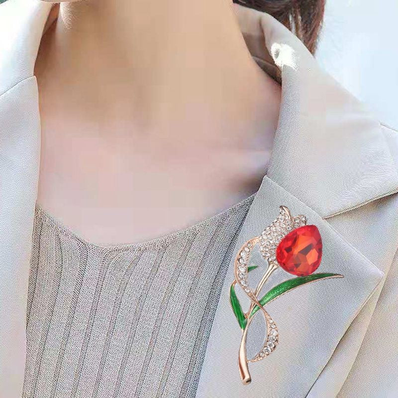 Stylish red rose brooch on a black background