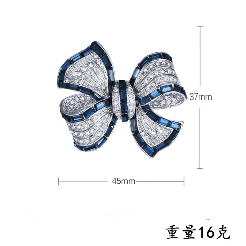 Chic Butterfly Knot Brooch with Zircon on grey background