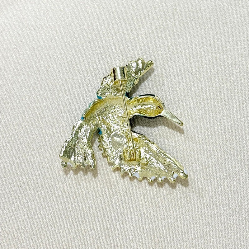 Bird enamel brooch showcasing vibrant colours