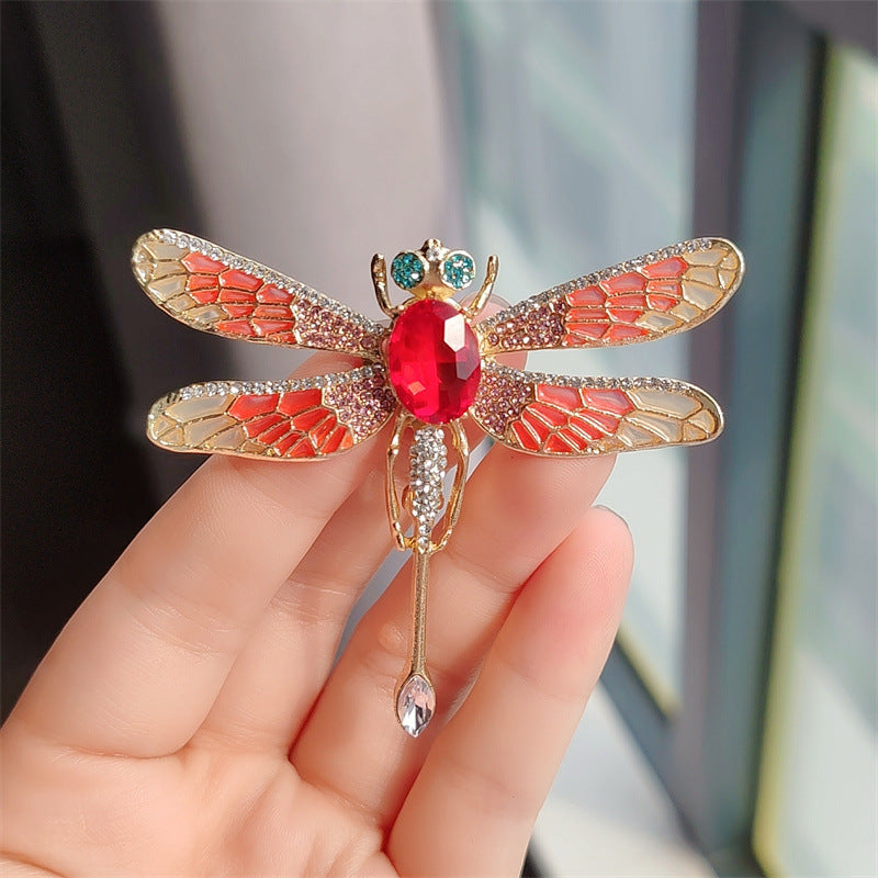 Colourful dragonfly pin close-up