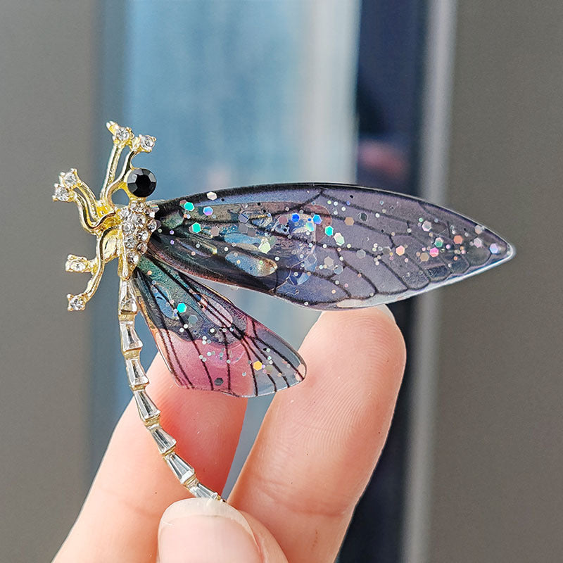 Close-up detail of colourful acrylic dragonfly brooch