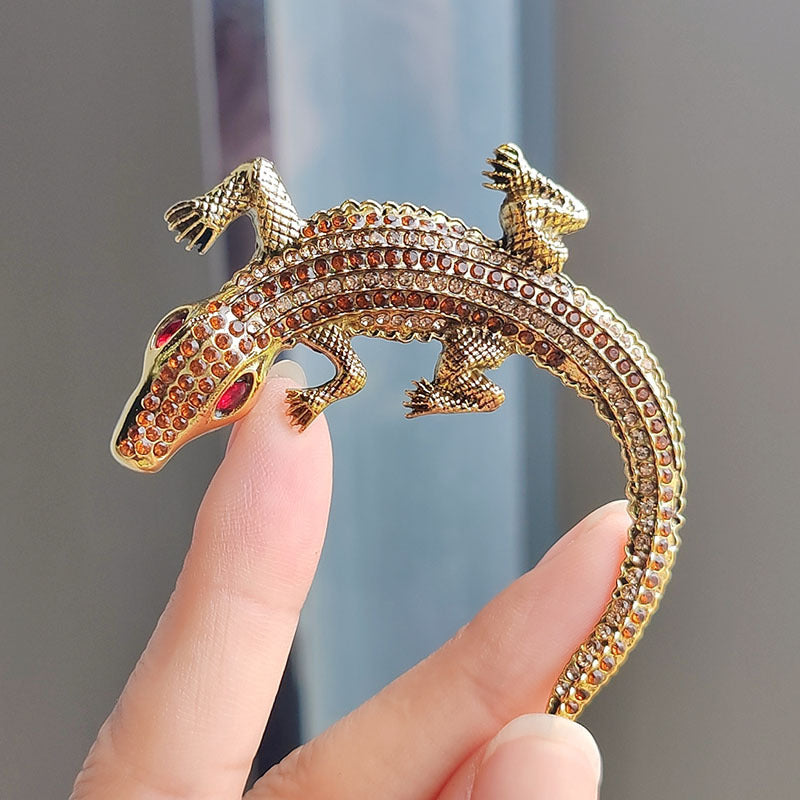 Close up of alloy crocodile brooch with rhinestones
