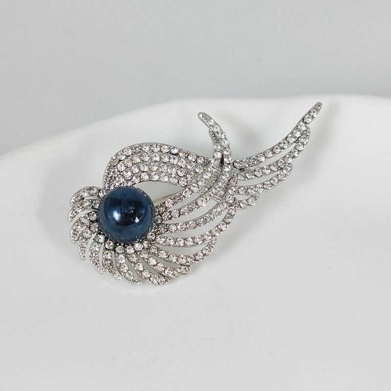 Elegant brooch with pearl on a detailed background