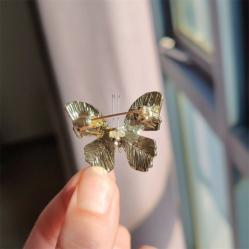 Rhinestone butterfly brooch on a coat