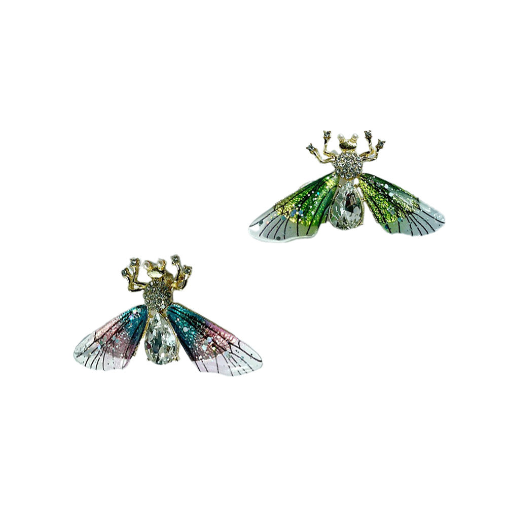 Chic pink bee brooch showcased on fabric