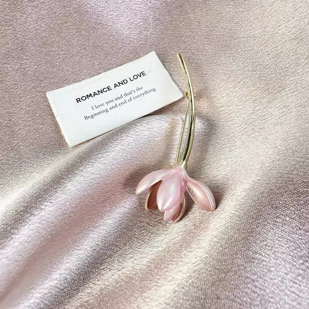 Detailed view of pink brooch with floral details