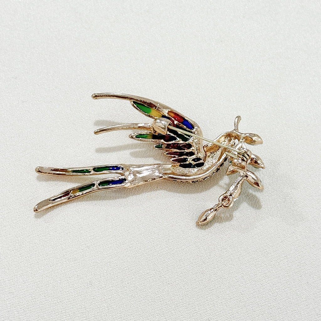 Elegant swallow brooch styled with a dress