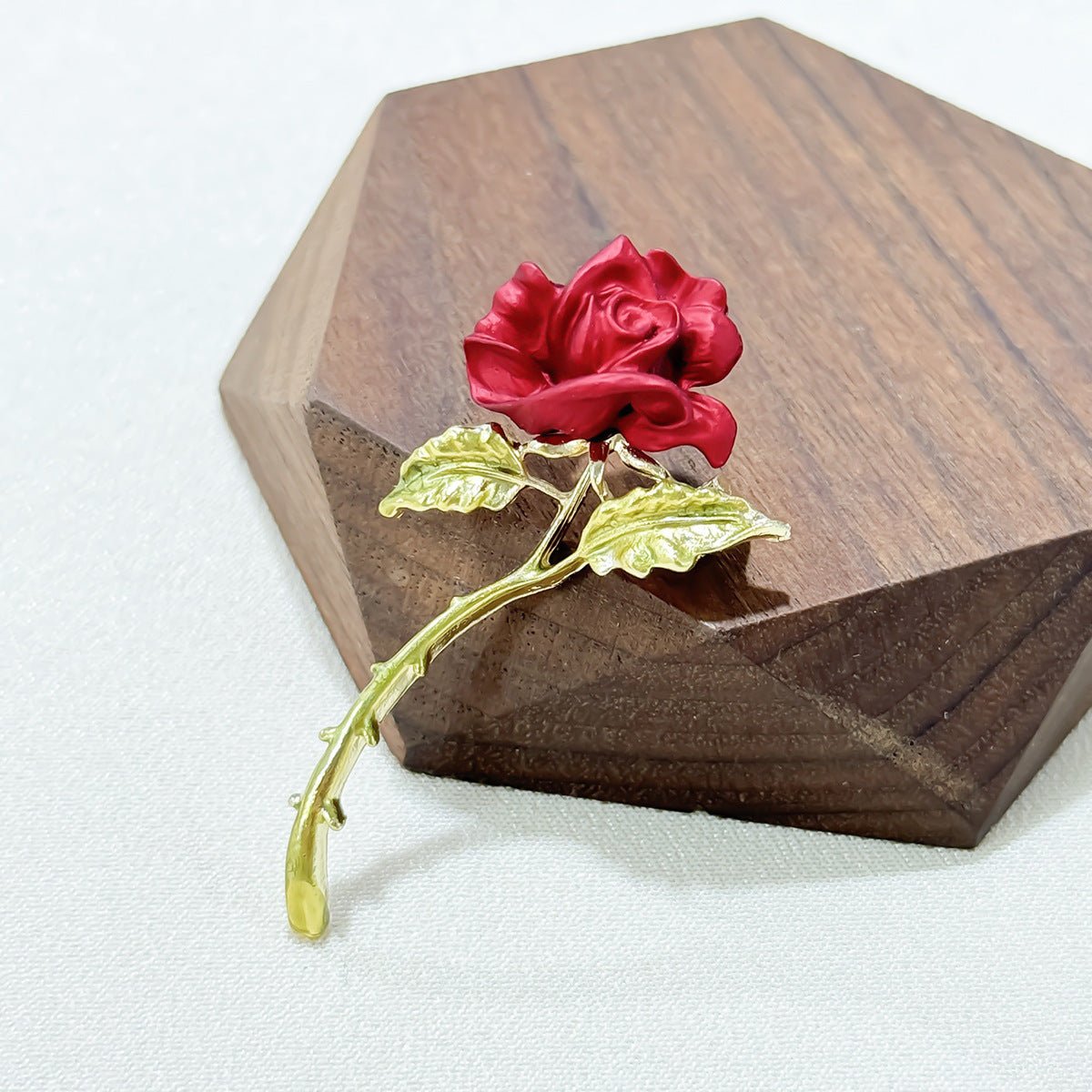 red rose brooch on a table