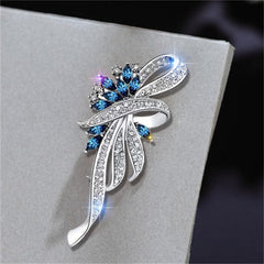 Close-up of blue gemstone floral brooch