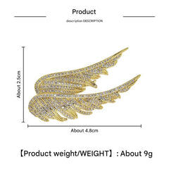 Angel wings brooch showcased on a clothing rack
