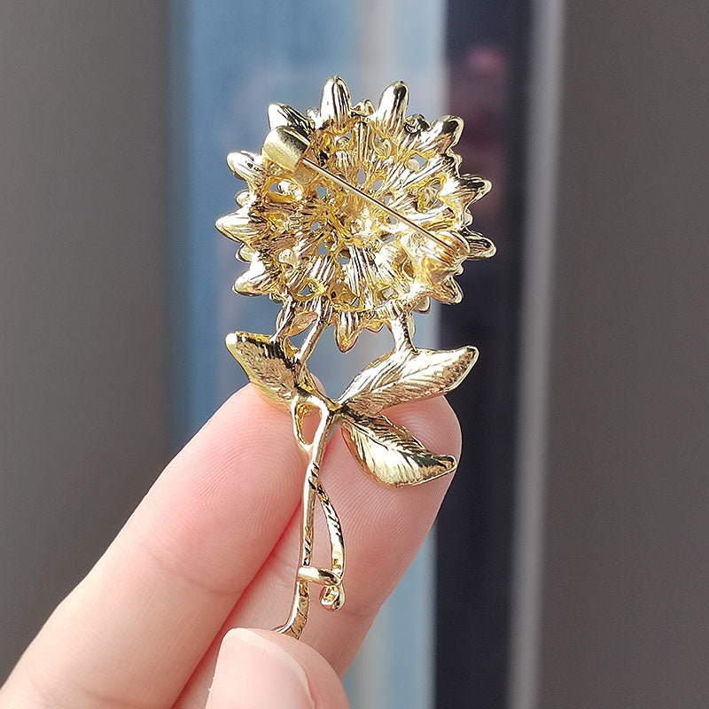 Close-up of sunflower brooch with crystals