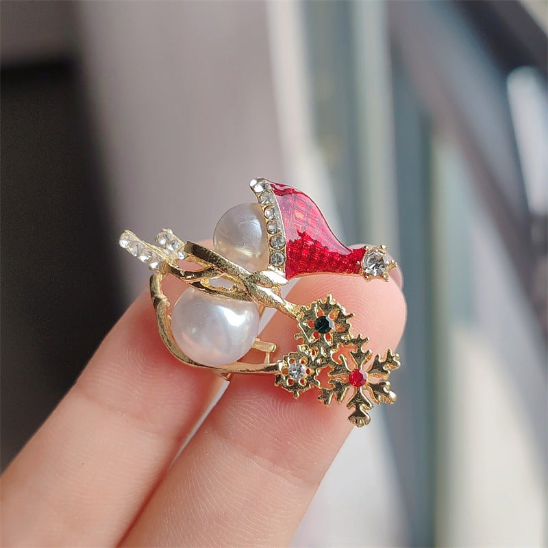 Snowman brooch displayed in a festive setting