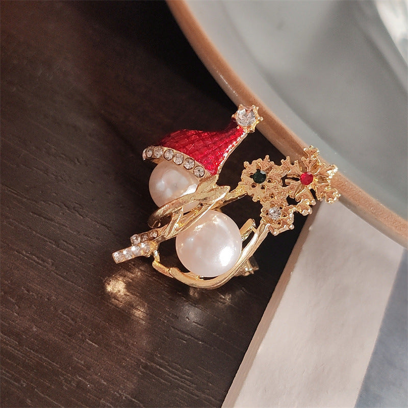 Close-up of Cute Christmas Pearl Snowman Brooch
