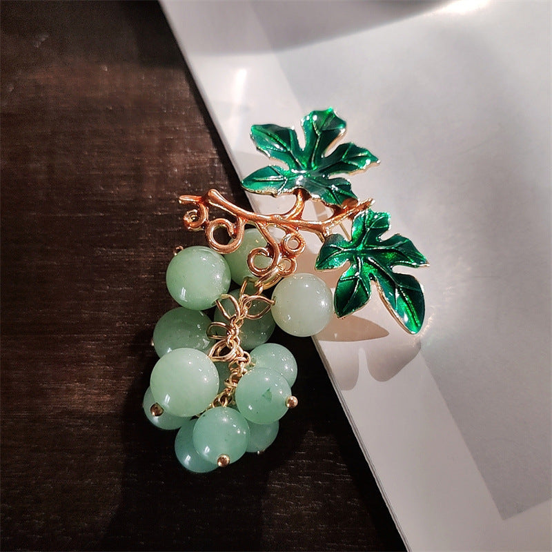 Vibrant fruit motif pin brooch on display