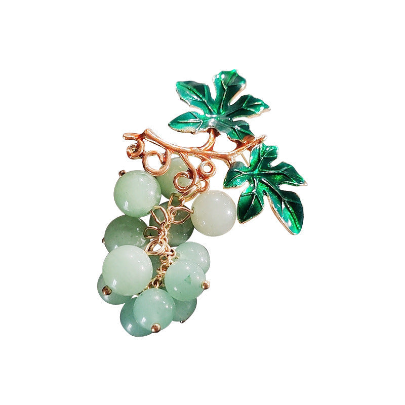 Elegant pin brooch with fruit design on model