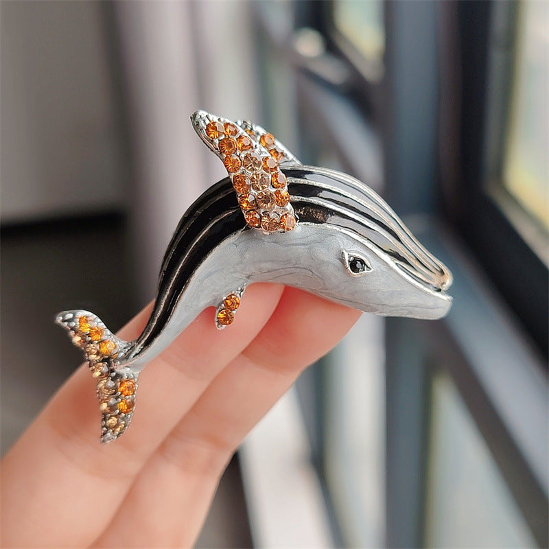 Close-up of elegant whale and dolphin brooch