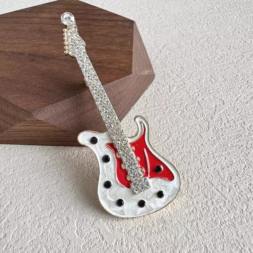 Guitar-shaped brooch with sparkling rhinestones