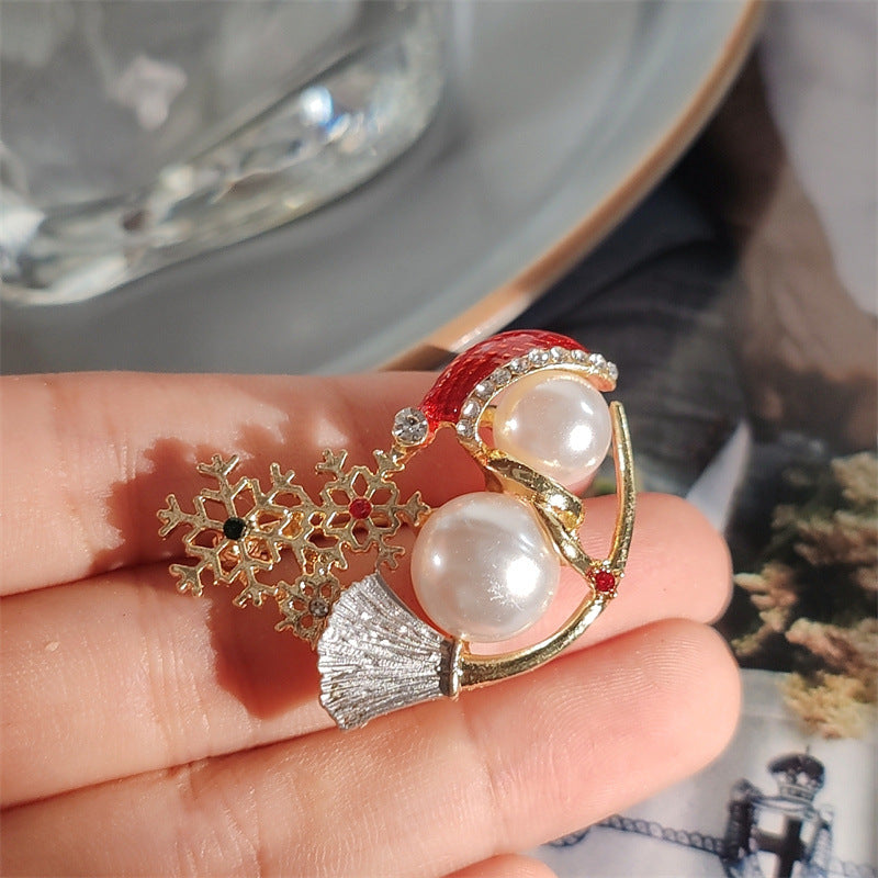 Cute snowman brooch with pearls on white background
