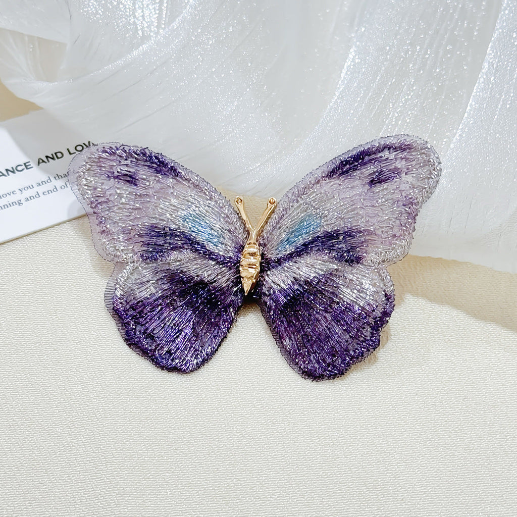 Close-up of floral brooch with butterfly design
