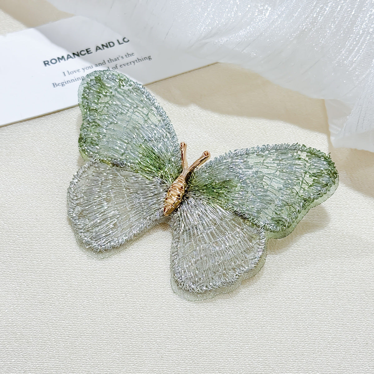 Side view of colourful butterfly brooch