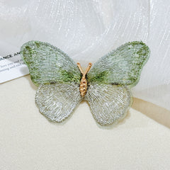 Vibrant coloured brooch placed on fabric