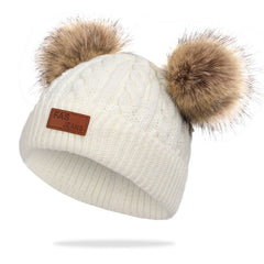 Knit hat and scarf set laid out on a snowy background