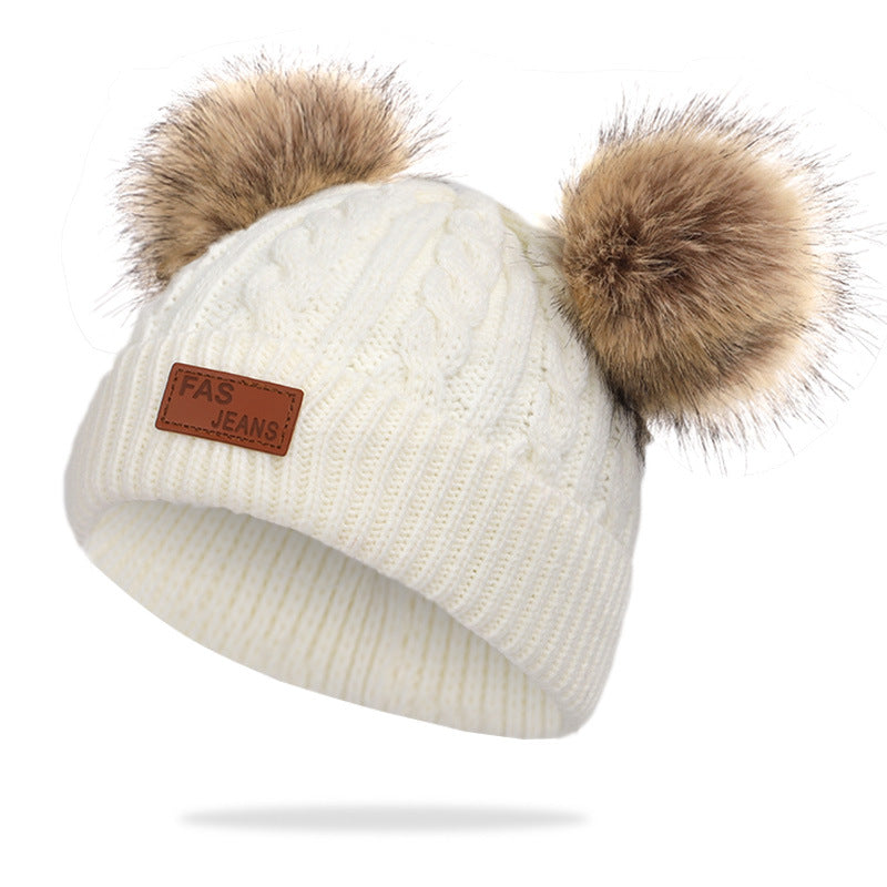 Knit hat and scarf set laid out on a snowy background