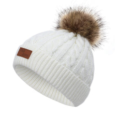 Knit hat and scarf set laid out on a snowy background