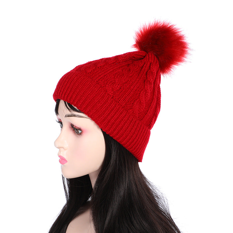 Dark grey knit beanie with pom pom displayed