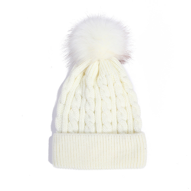 Pink knit beanie with pom pom details
