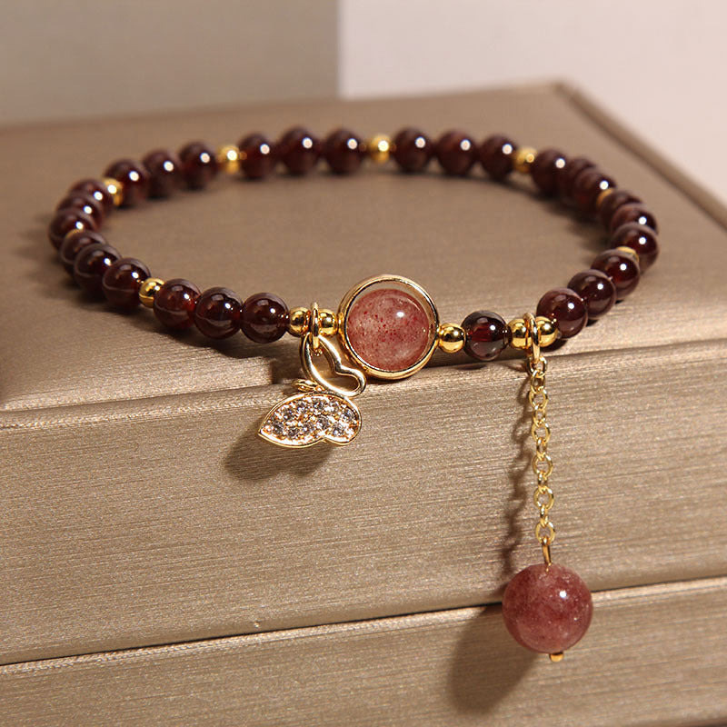 Creative view of garnet and butterfly bracelet