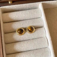 Pair of tiger eye earrings on model