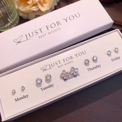 Stylish S925 silver earrings against pastel background