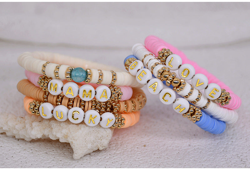 Elegant friendship bracelet stacked with other jewellery