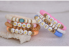 Elegant friendship bracelet stacked with other jewellery
