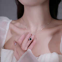 Close-up details of the four-leaf clover pendant